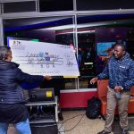 Sheba-Hirst-hands-over-Lawrence-Murage-his-cheque